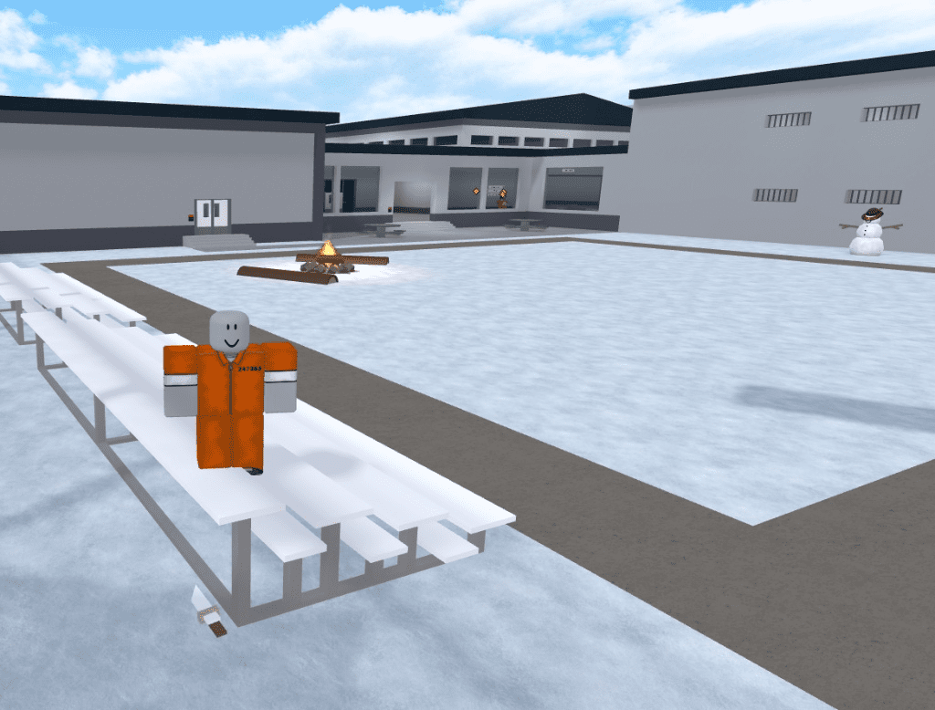 A prisoner standing on white bleachers with a Crude Knife hidden on the ground beneath the seats