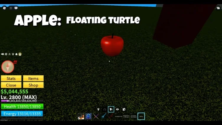 An apple rests on the grass near a large tree on Floating Turtle Island.