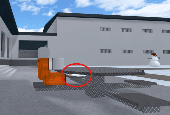  An inmate sitting at an outdoor diamond-plate table with a crud knife