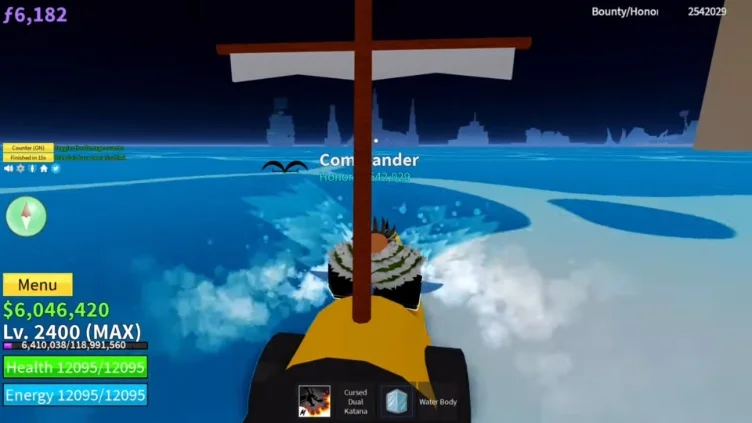A boat traveling across the ocean towards a dark island in the distance.
